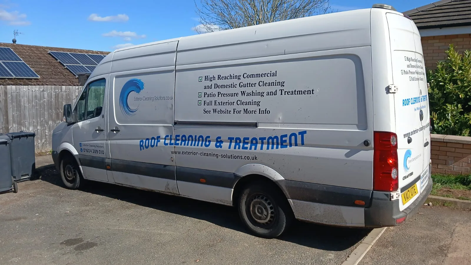 Exterior Cleaning Solutions branded van showing full service list - roof cleaning, pressure washing, gutter cleaning, exterior cleaning
