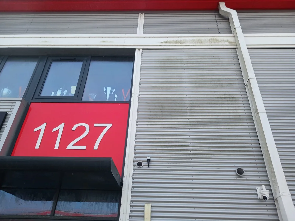 Commercial unit metal cladding before cleaning - staining and dirt visible