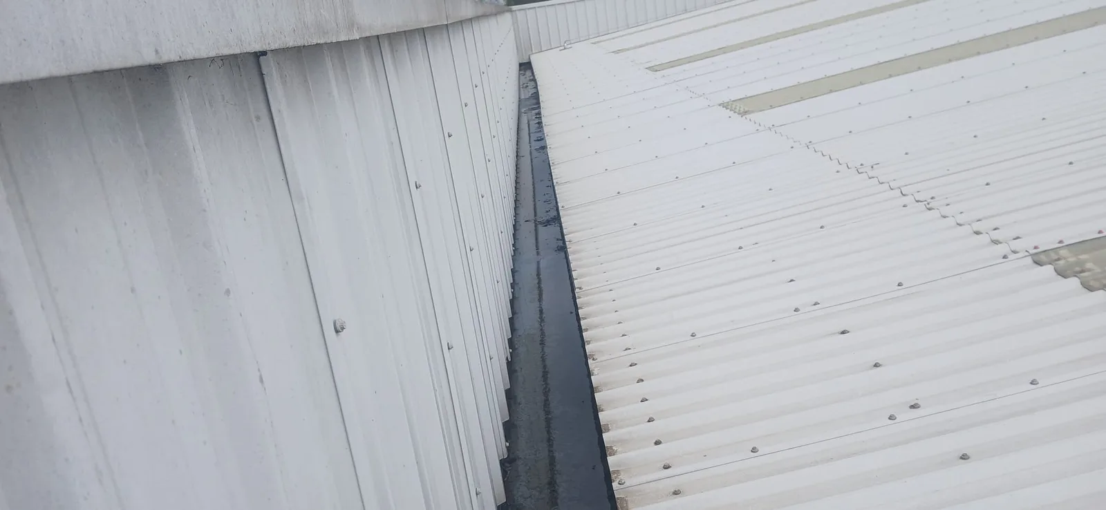 Commercial box gutter after clearing - clean and flowing freely