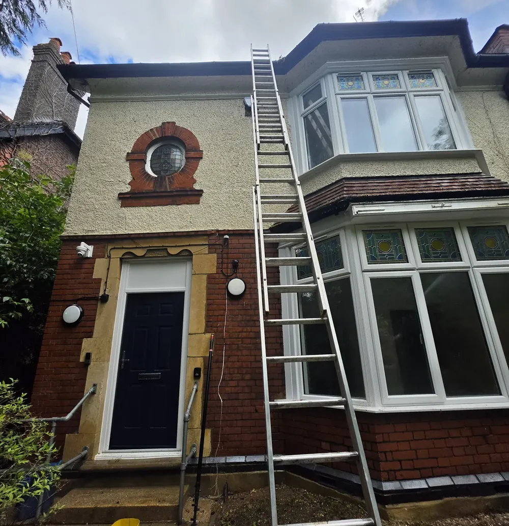 Typical Luton property - brick walls, painted render and a clay-tiled extension roof cleaned by ECS