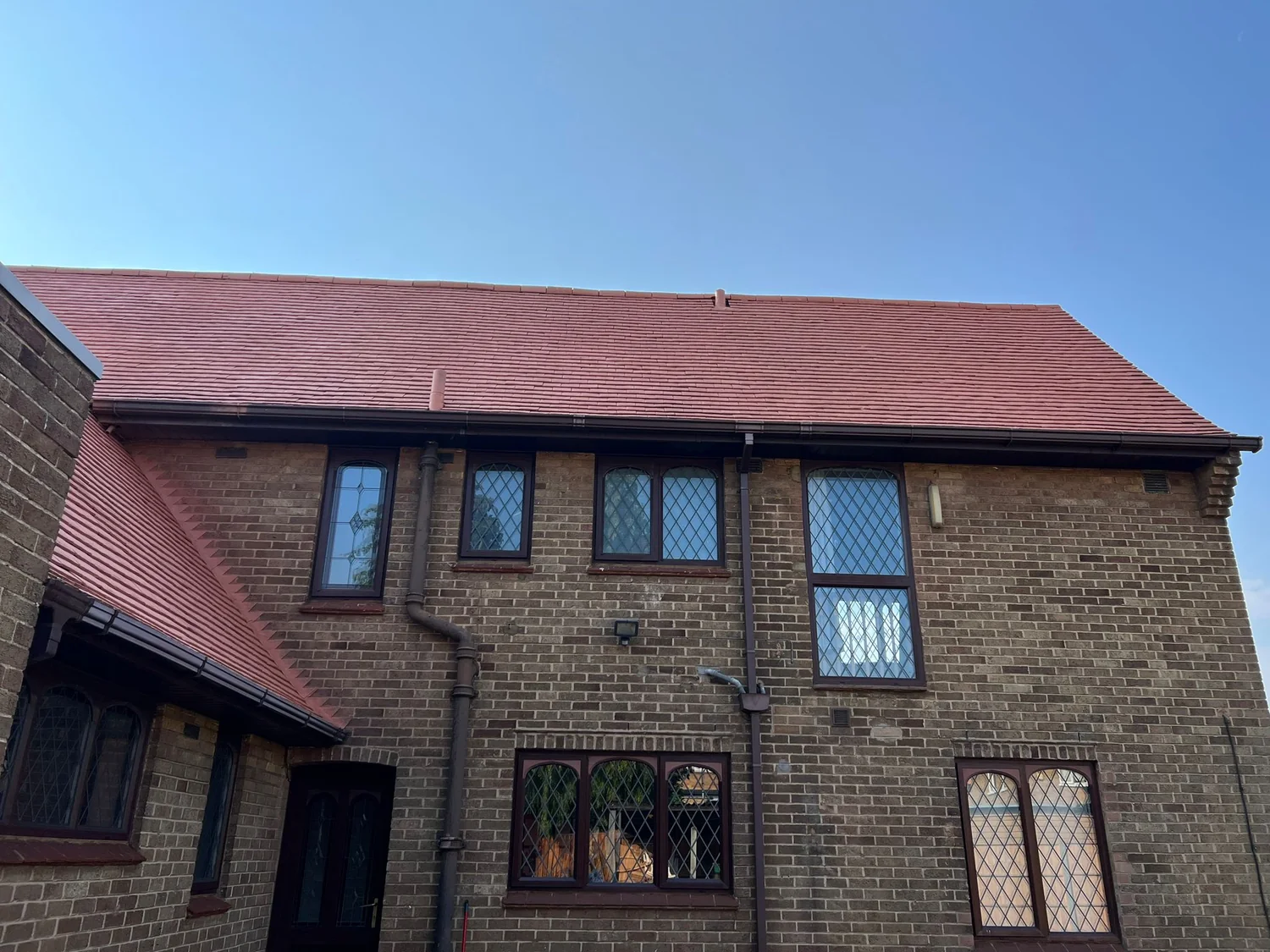 Clay tile roof after professional cleaning and painting in Northampton