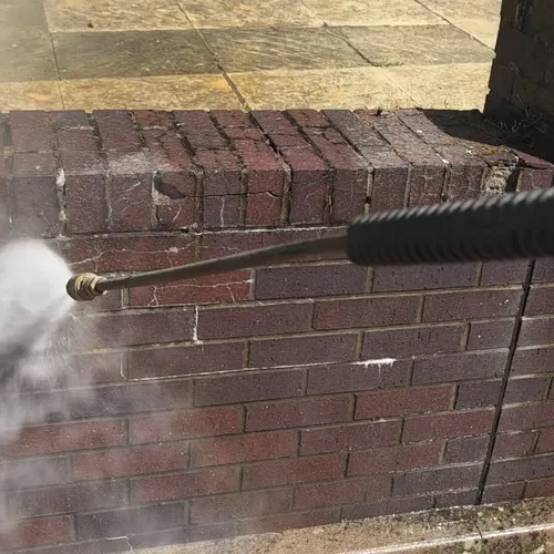 During - commercial red brick boundary wall pressure washed algae removal, Rugby.