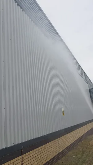 commercial building grey metal cladding water fed pole rinse