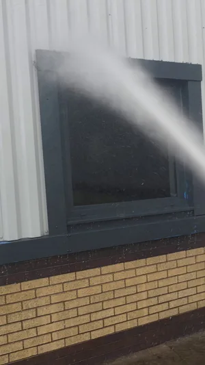 During - commercial building metal cladding window water fed pole rinse, Rugby.