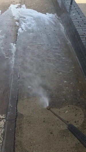 During - commercial concrete path pressure washed algae foam mid pass, Rugby.