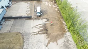 During - commercial concrete yard pressure washed algae removal mid clean, Rugby.