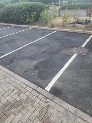 After - commercial car park tarmac block paving algae pressure washed clean, Rugby.