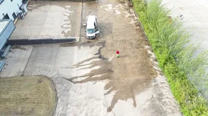 During - commercial concrete yard pressure washed algae moss removal aerial, Rugby.