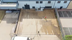 During - commercial concrete yard pressure wash algae removal aerial, Rugby.