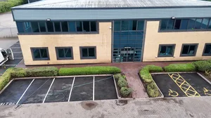 During - commercial building buff brick facade car park pressure washed tarmac, Rugby.