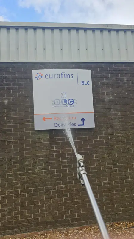 Soft wash spray applied to the brick wall directly below the Eurofins BLC Leather Technology Centre reception plaque