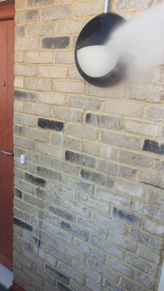 During - residential buff brick wall black algae pressure washed, Cambridge.