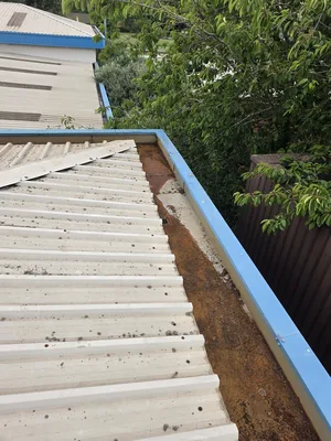 commercial building steel gutter severe rust corrosion algae spotting