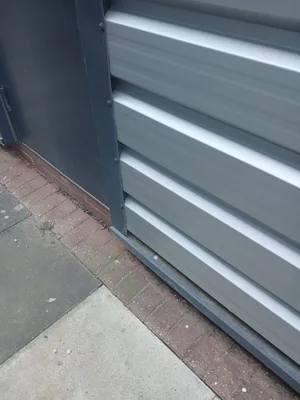Before - commercial industrial unit metal cladding base plinth biofilm soiling, Dunstable.