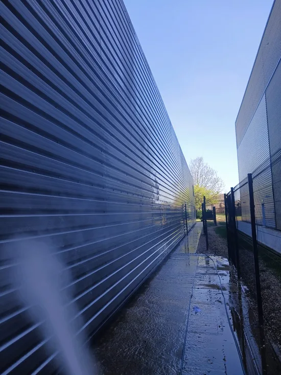 Before - commercial industrial unit metal cladding base plinth biofilm soiling, Dunstable.
