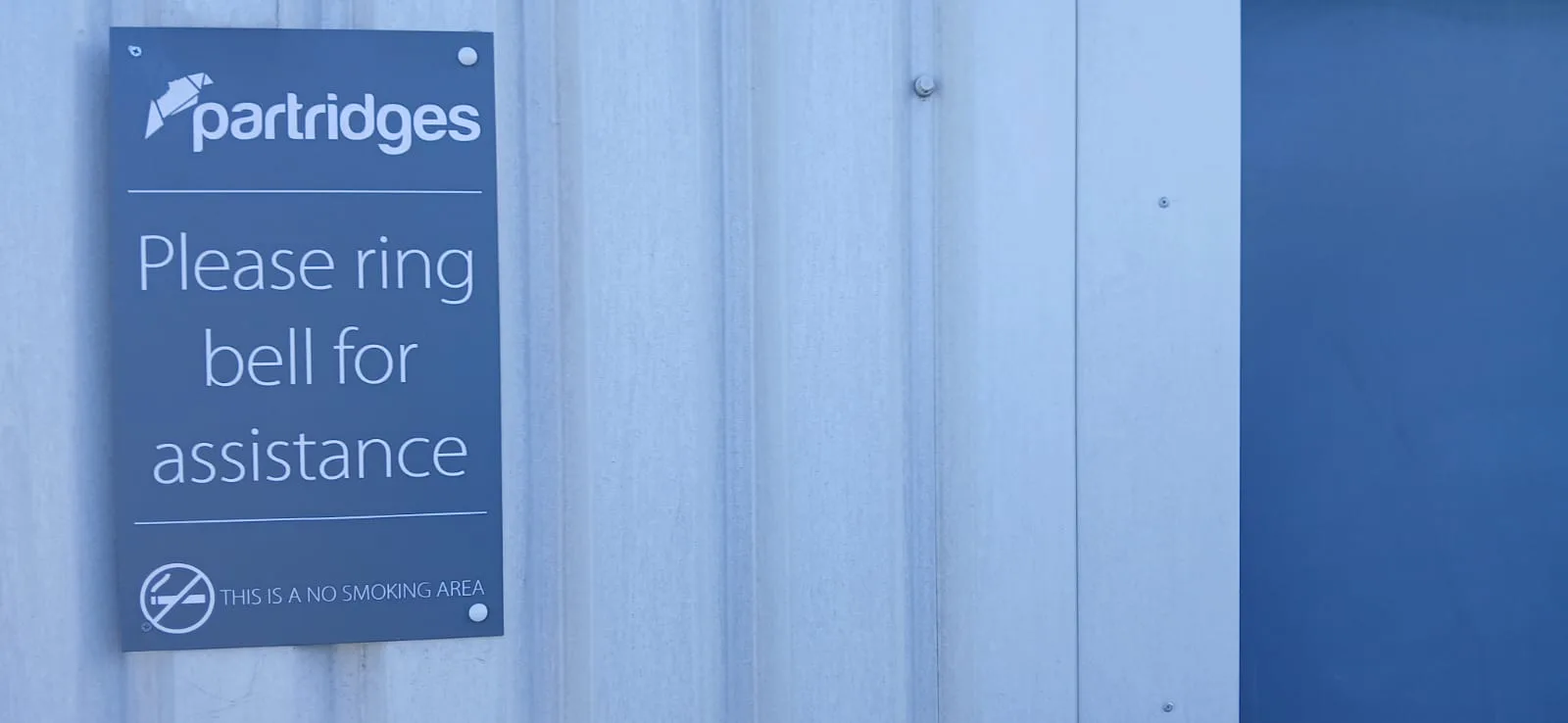 Partridges warehouse signage on clean cladding after exterior cleaning, Desborough