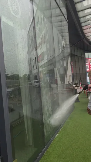 commercial venue large glazing panels exterior water fed rinse