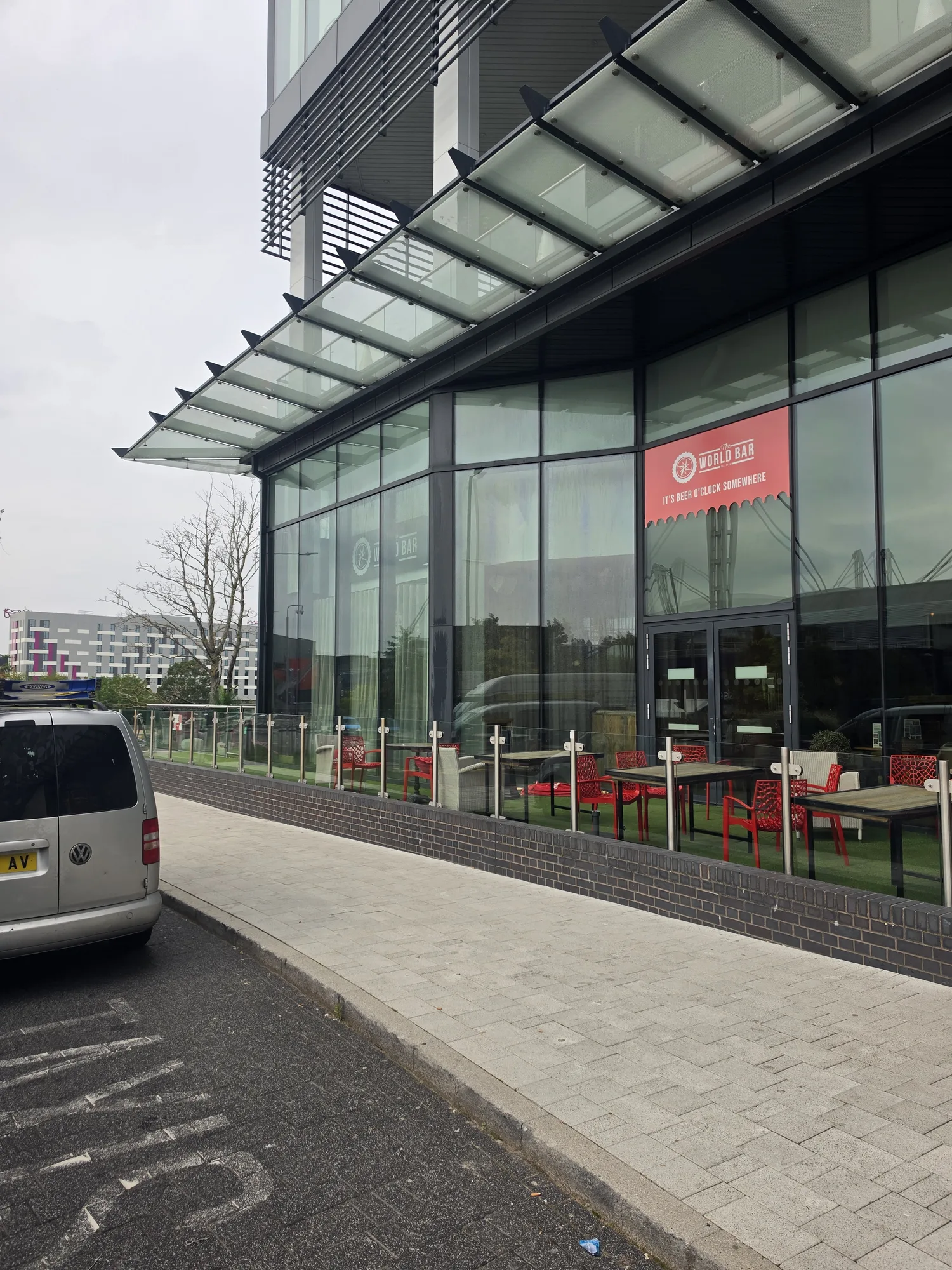Wide view of the glazed frontage at Resort World Birmingham with the service van on the approach