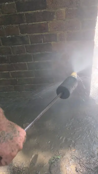 Brickwork being pressure washed to remove algae - Luton