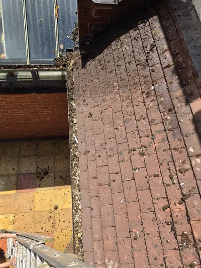 Concrete roof tiles before cleaning, moss and debris - Luton