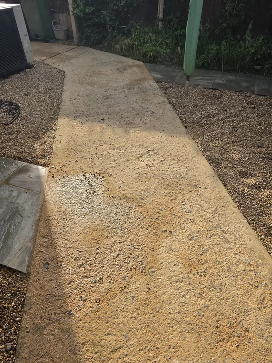After - concrete path pressure washed showing exposed aggregate, clean section meeting the soiled stretch, Orlingbury.