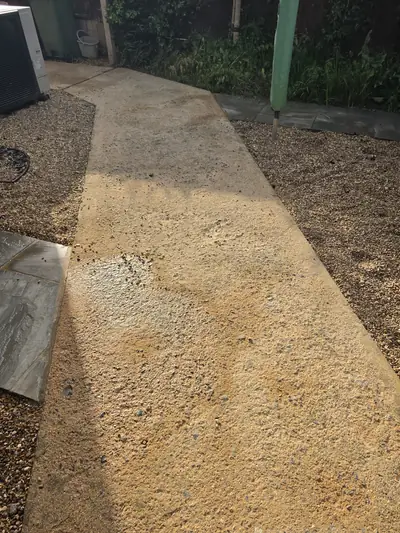 Pebbledash render wall mid-clean, dirty-to-clean contrast - Orlingbury