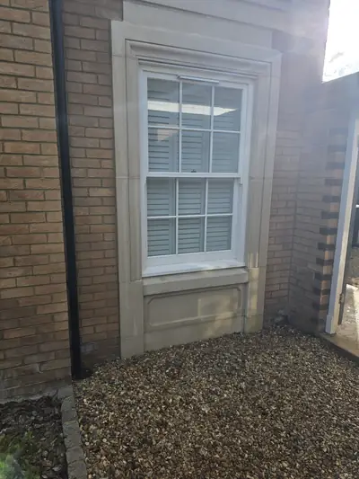Clean red brick window with stone surround and quoin detailing after cleaning - Orlingbury