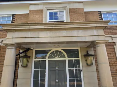 Grand entrance with sandstone columns and portico before cleaning - Orlingbury