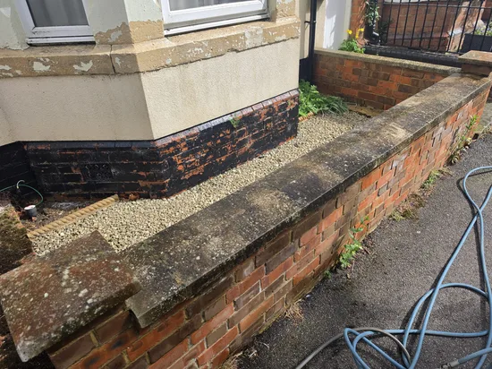 Before - residential red brick boundary wall lichen algae stained coping, Northampton.