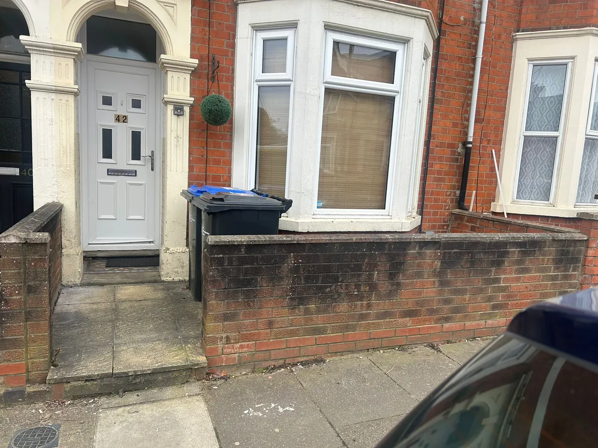 Victorian red brick garden wall after cleaning - algae and organic staining removed, Northampton