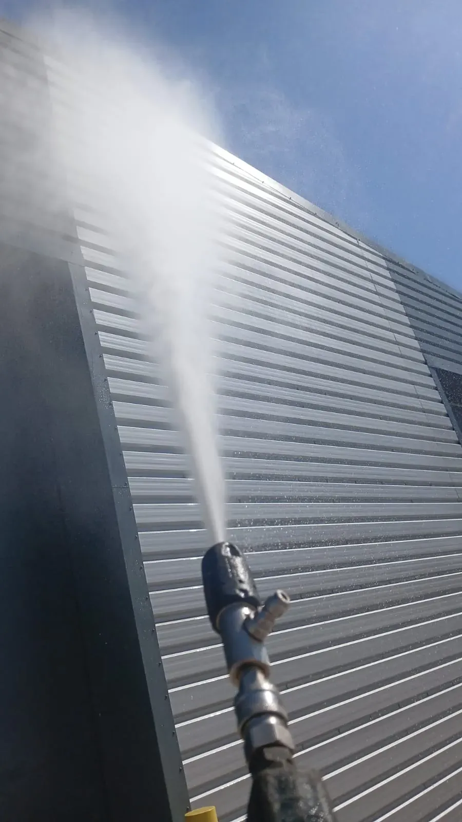 Commercial metal cladding facade during steam cleaning - Dunstable, Bedfordshire
