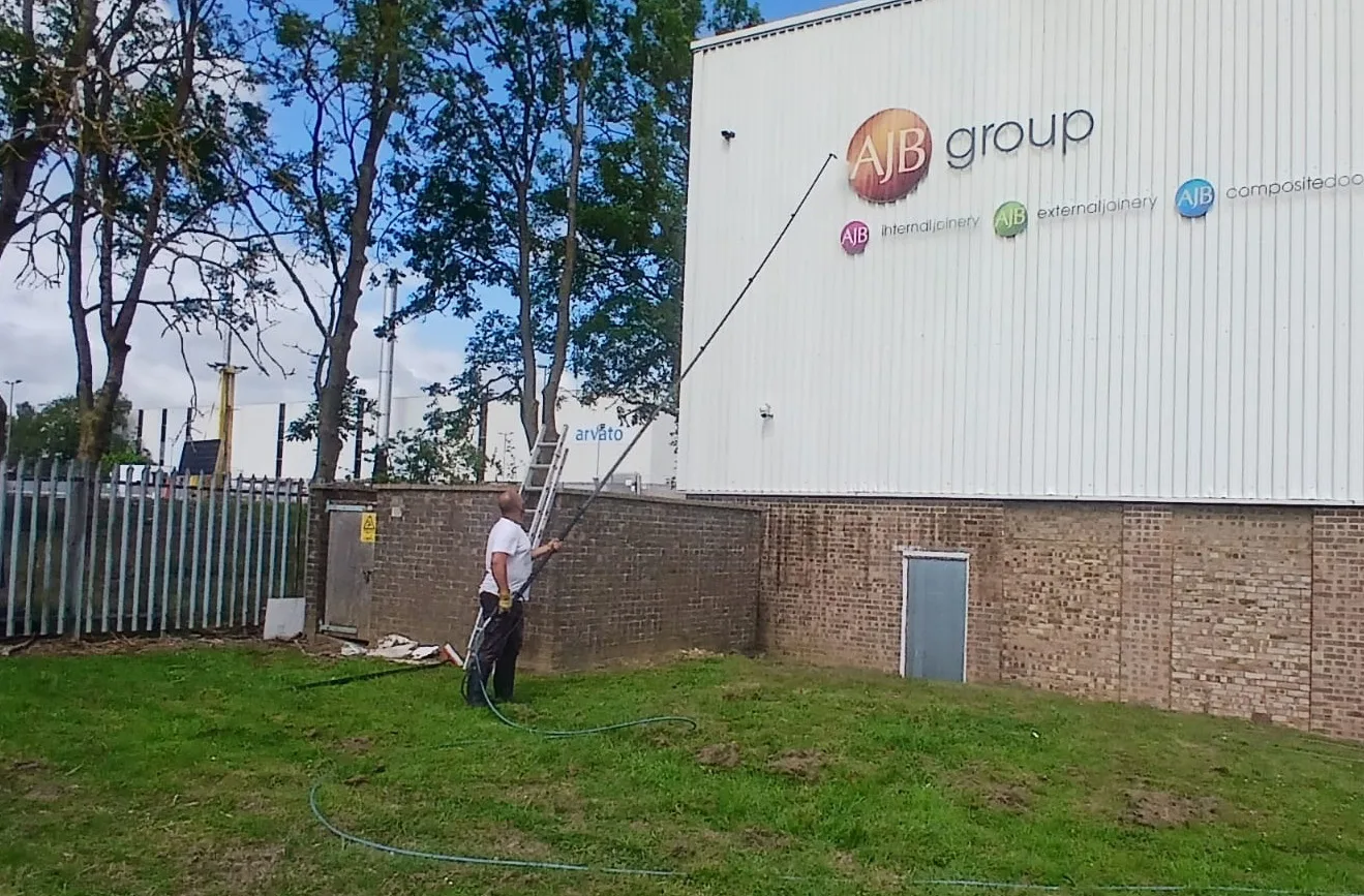 Warehouse cladding jet washing at AJB Group, Corby - exterior cleaning in progress