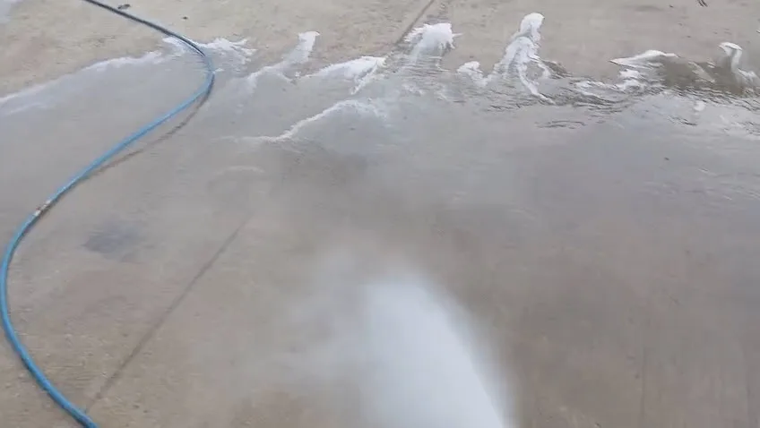 Driveway pressure washing in progress showing clean concrete, Lung Wah Chong Oxford