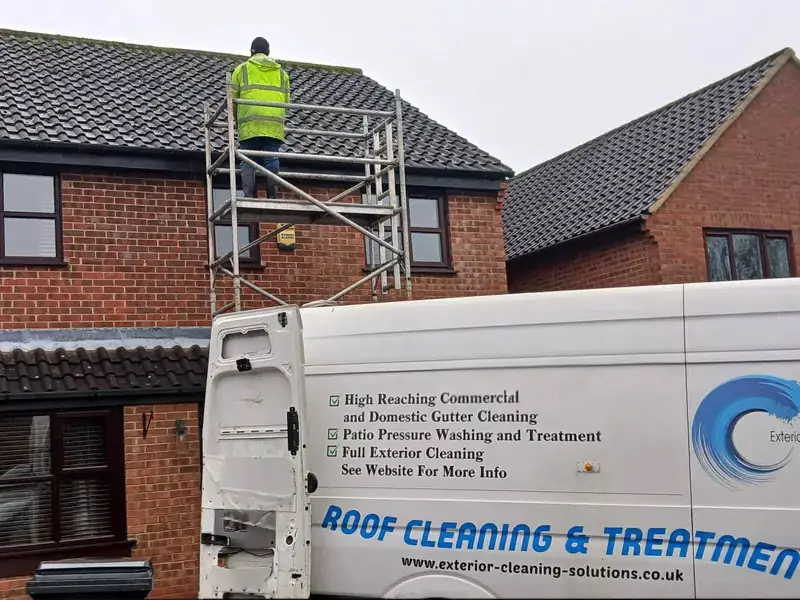 Branded Exterior Cleaning Solutions van reading Roof Cleaning and Treatment with an operative working on a roof behind