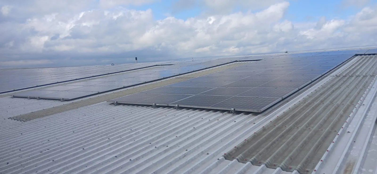 Large solar panel array on commercial warehouse roof - Partridges, Desborough