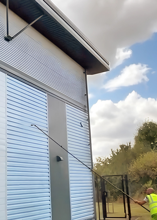 industrial siding being power cleaned