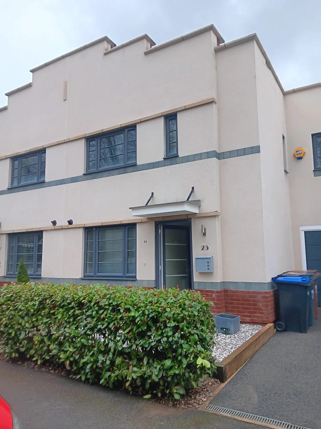 Clean modern residential property after professional render cleaning showing restored white walls and algae-free facade