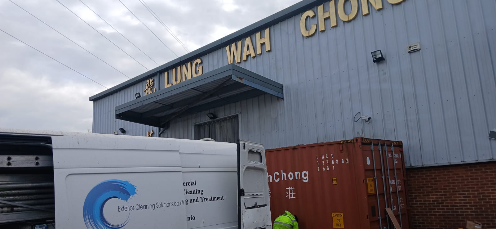 Commercial cleaning service van parked at Lung Wah Chong warehouse during professional exterior cleaning project in Oxford